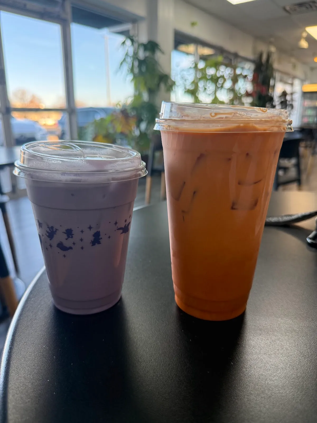 Taro milk tea and Vietnamese iced coffee on a cafe table