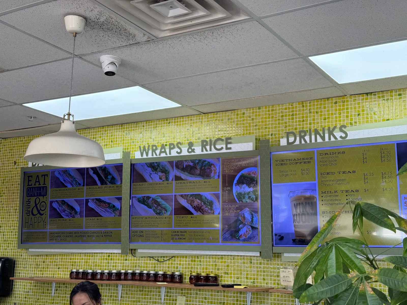 Overhead menu boards for banh mi, wraps and rice, and drinks